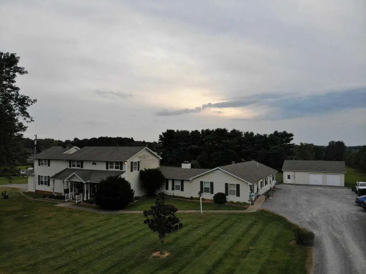 Aerial view of the facility's exterior with green lawn and buildings