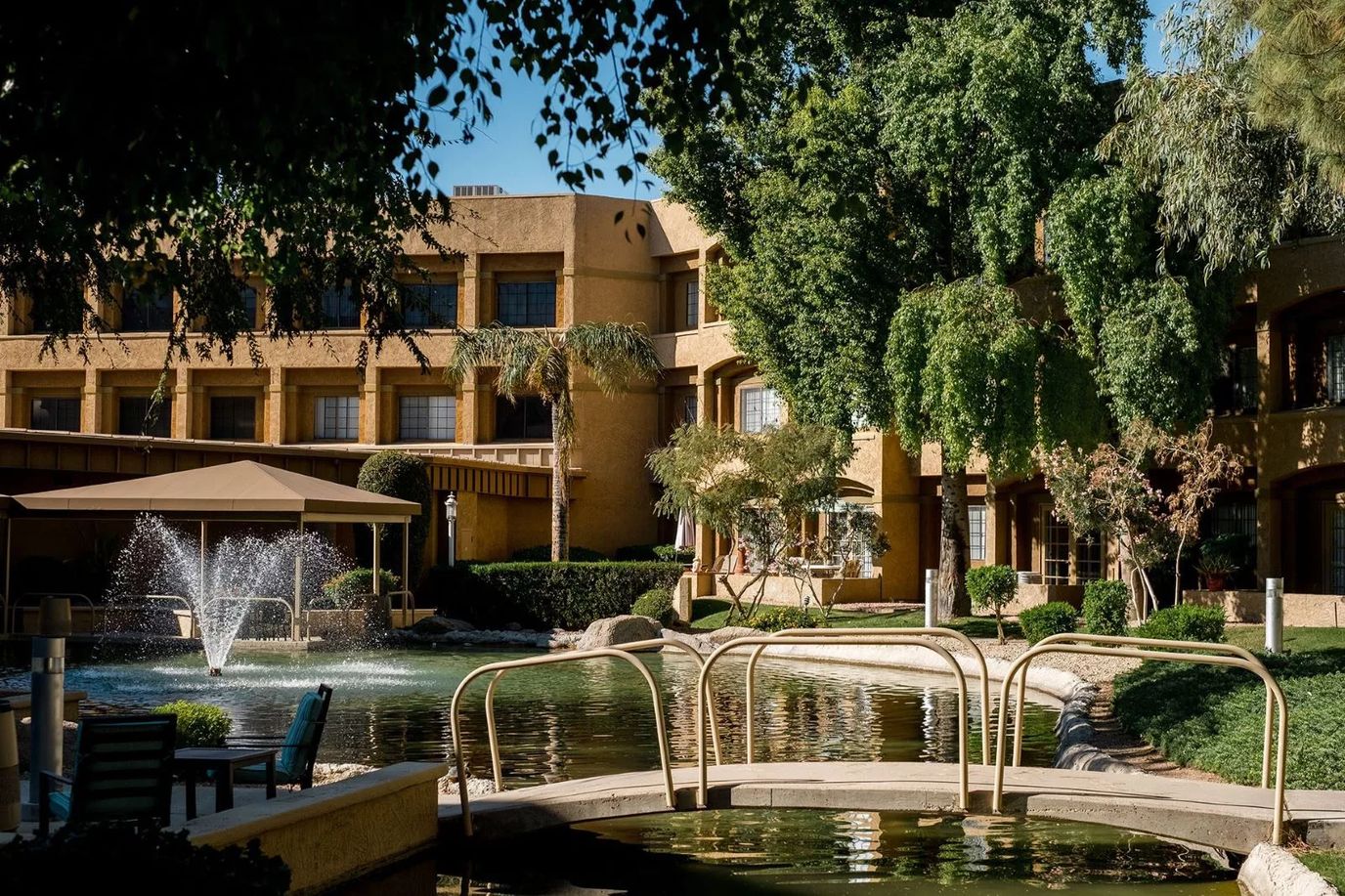 Outdoor area with a pond and fountain at Thunderbird Senior Living