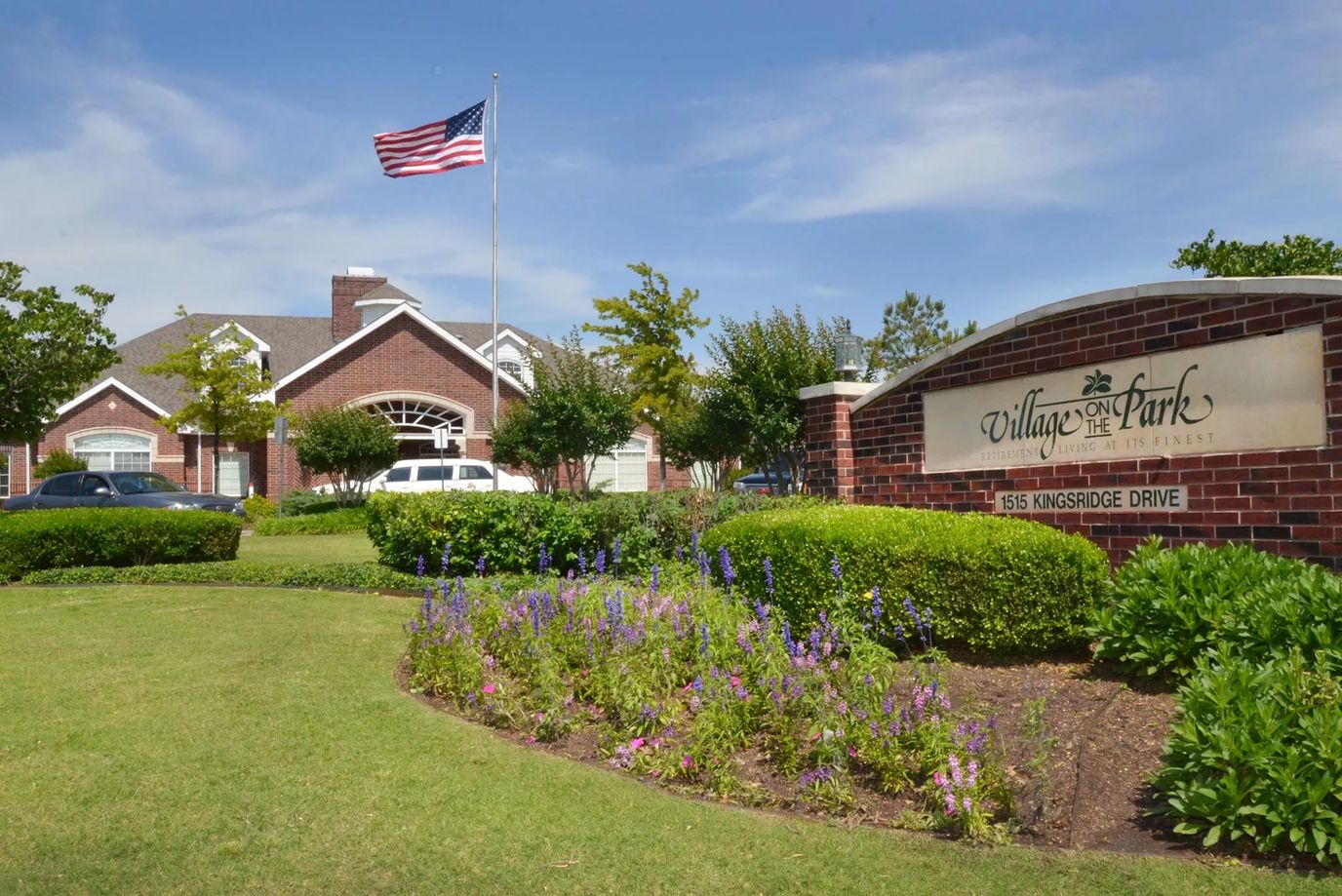 Exterior view of Village on the Park with landscaped grounds