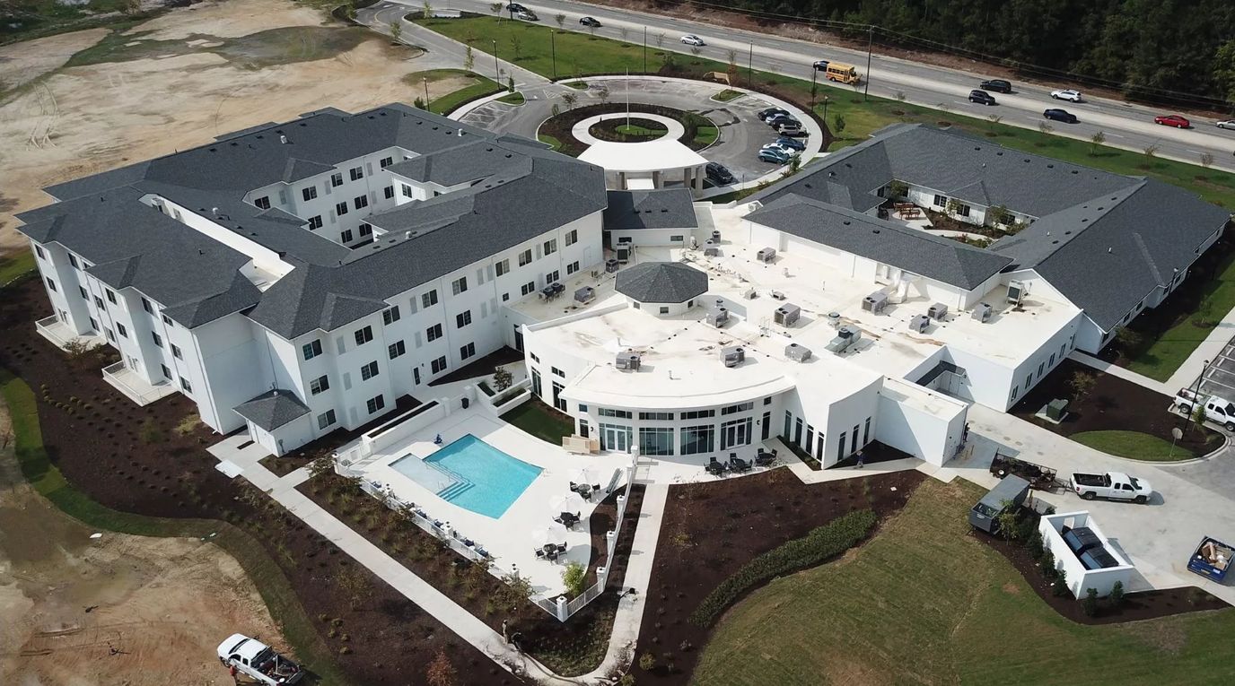 Aerial view of a modern assisted living facility with outdoor spaces