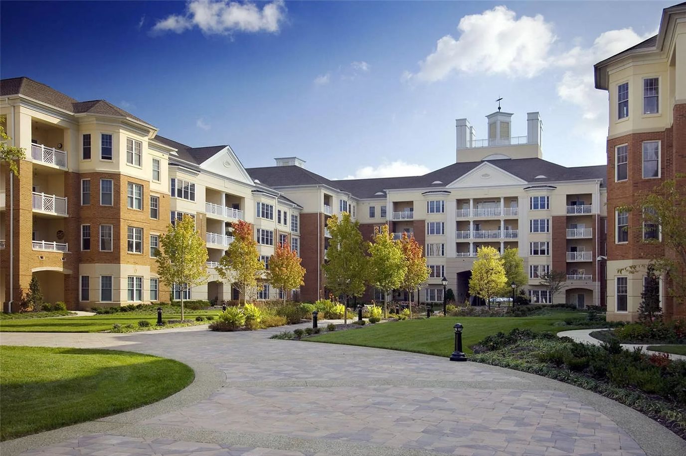 Exterior view of a senior living facility with gardens