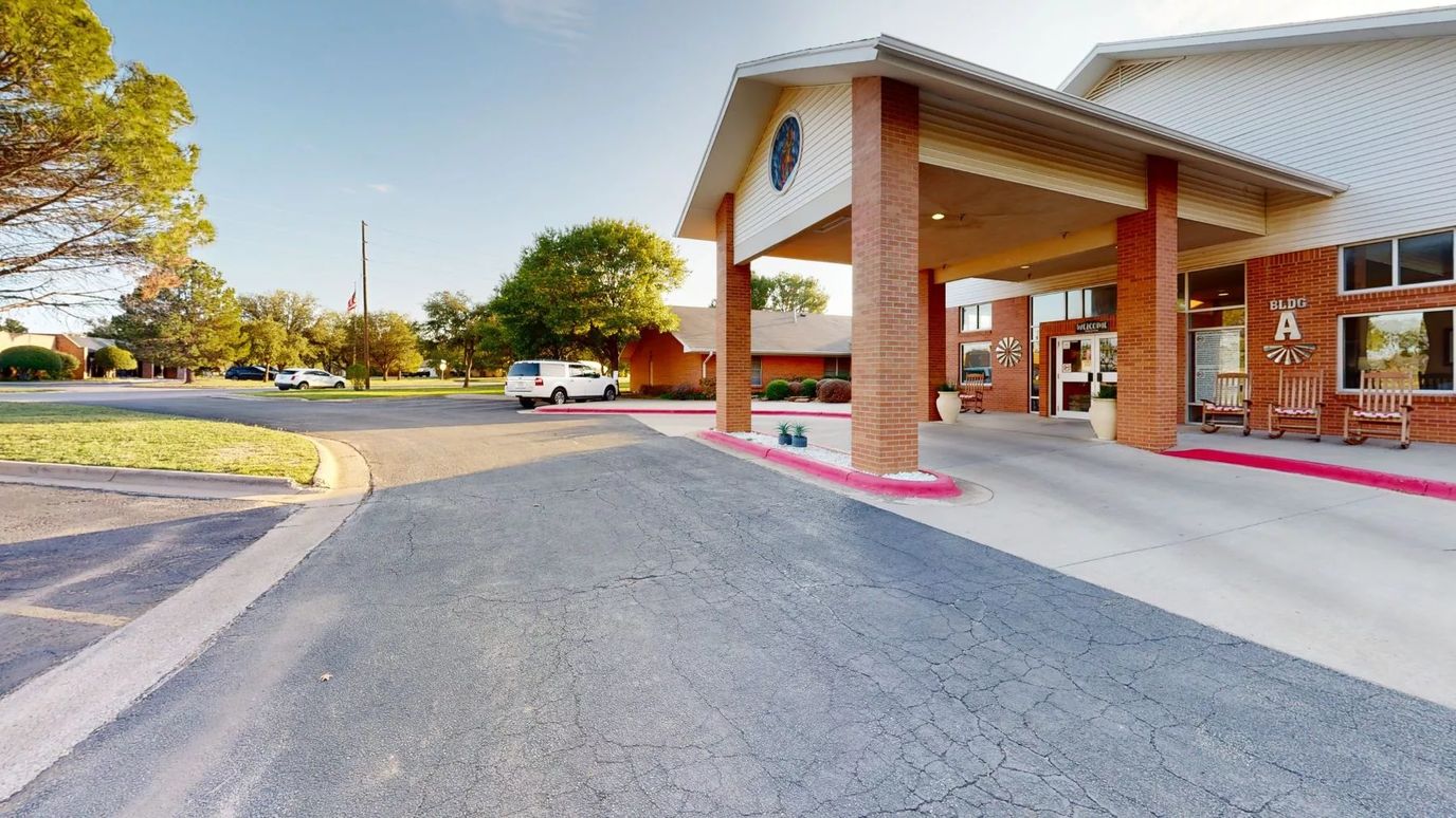 Entrance of Wisteria Place Retirement Living with parking area