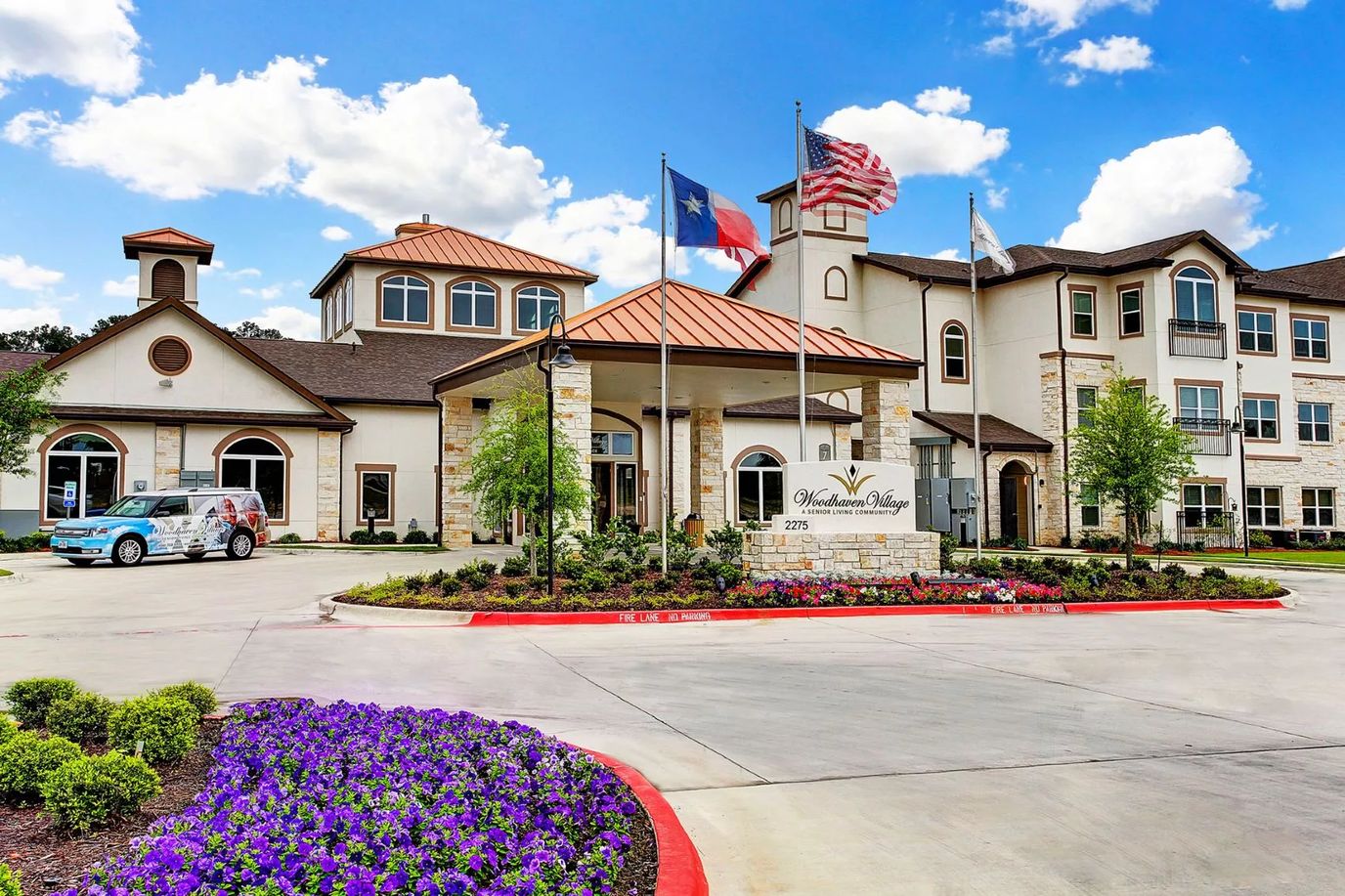 Exterior view of Woodhaven Village nursing home with flags