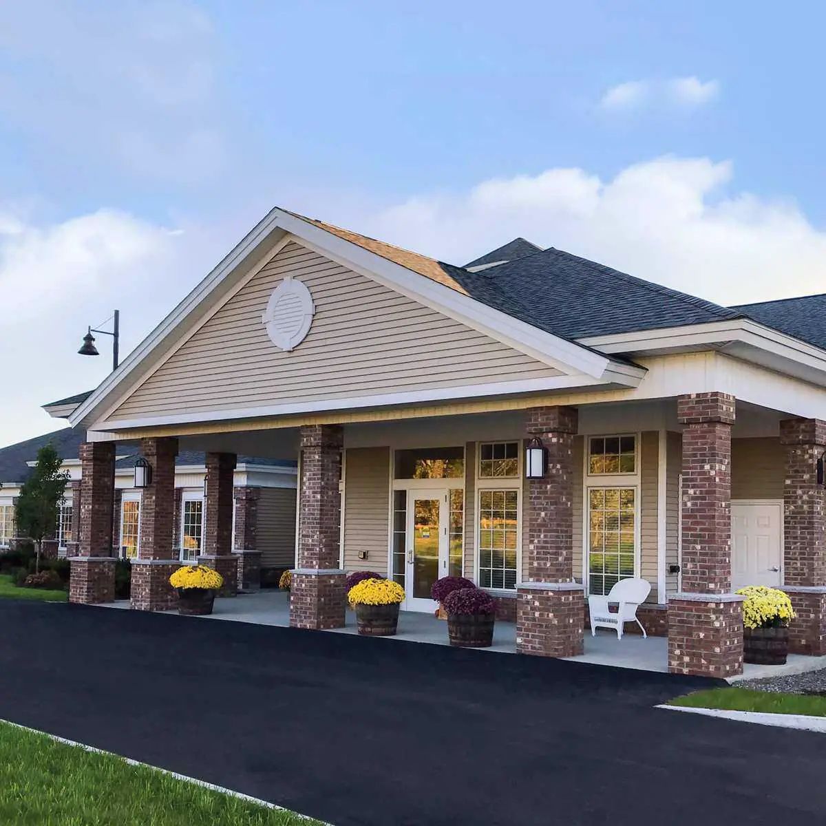 Exterior view of Woodlands Senior Living with flower pots