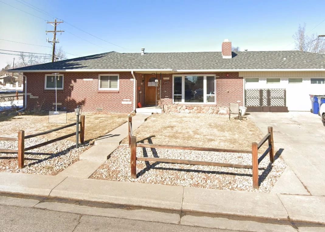 Exterior view of a single-story building with a garden