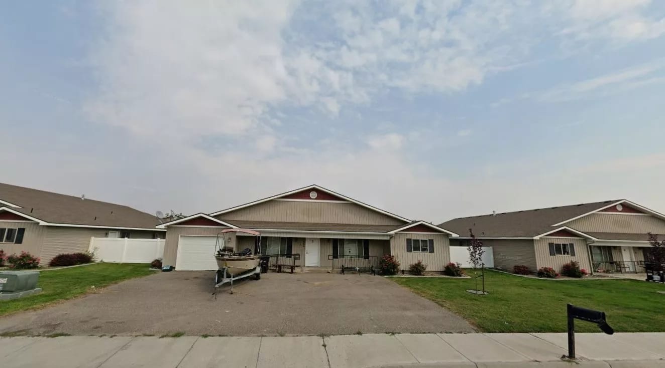 Exterior view of a senior living facility with garden space