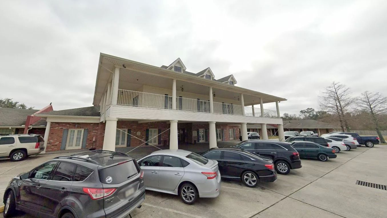 Exterior view of Ferncrest Manor with parking area