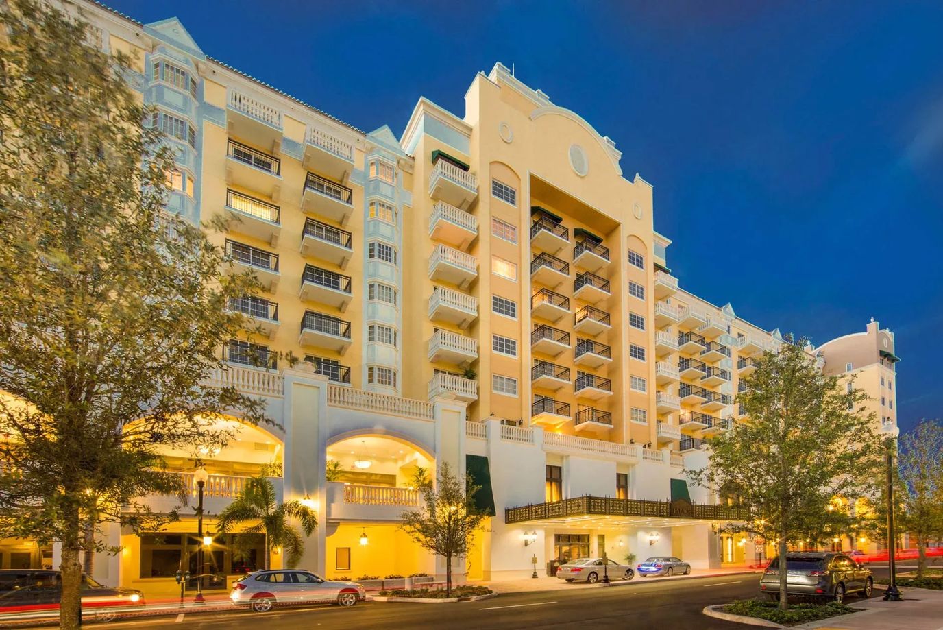 Exterior view of The Palace at Coral Gables building at night