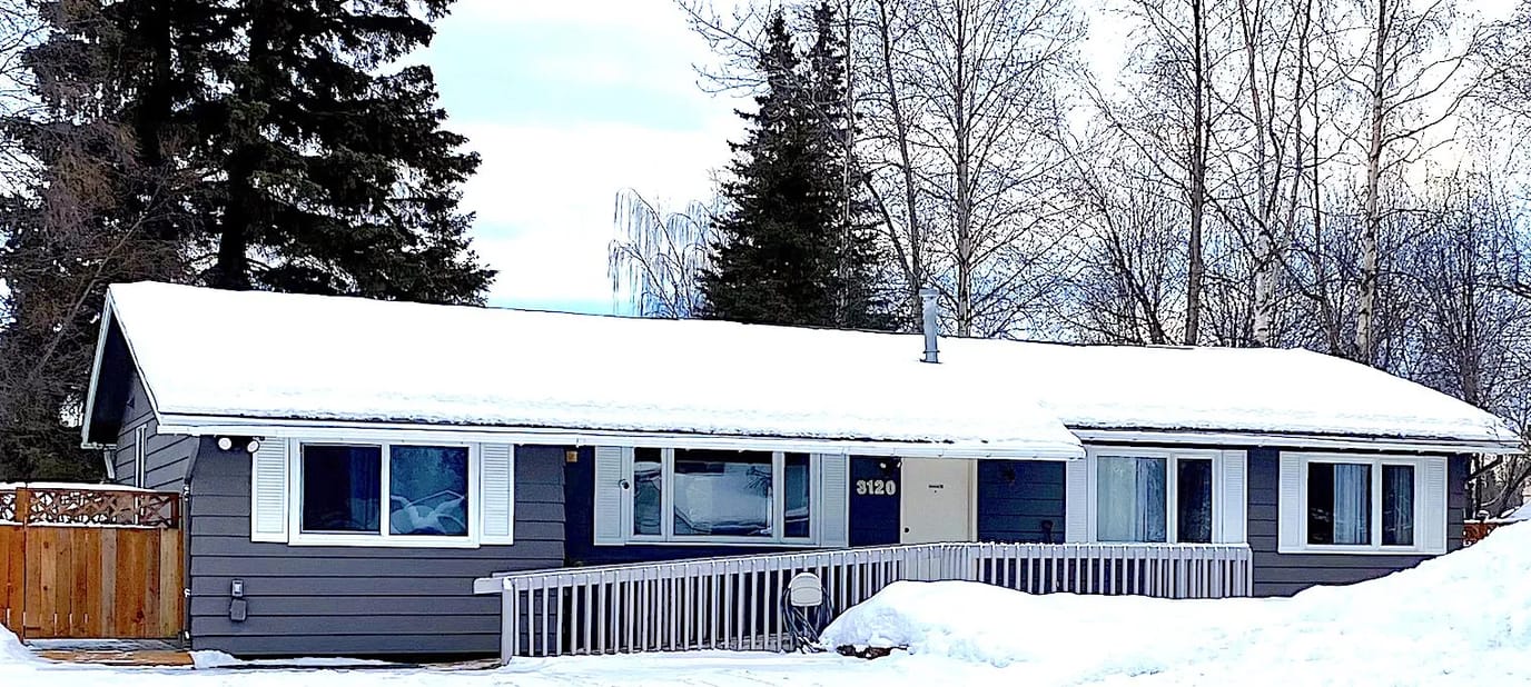 Exterior view of a residential assisted living facility covered in snow