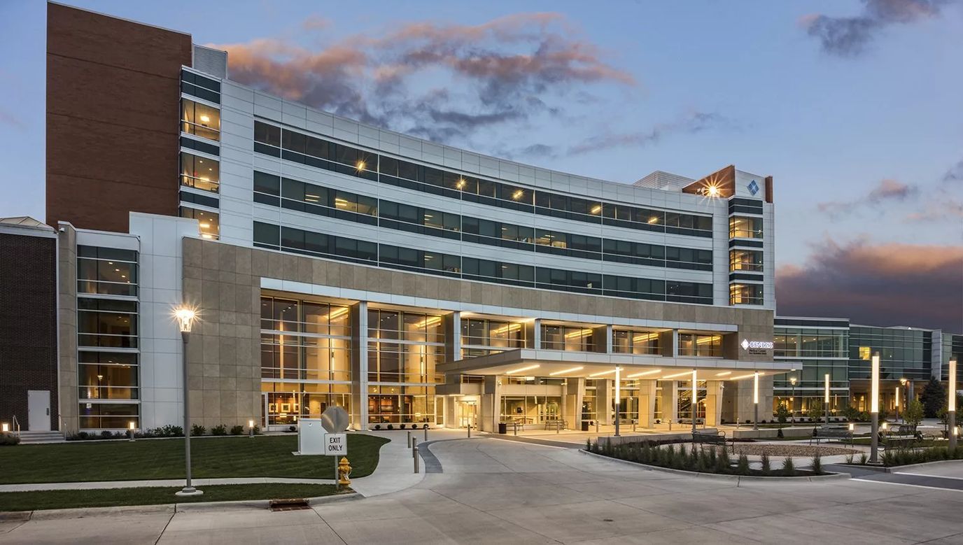 Exterior view of Genesis Palliative Care facility at dusk