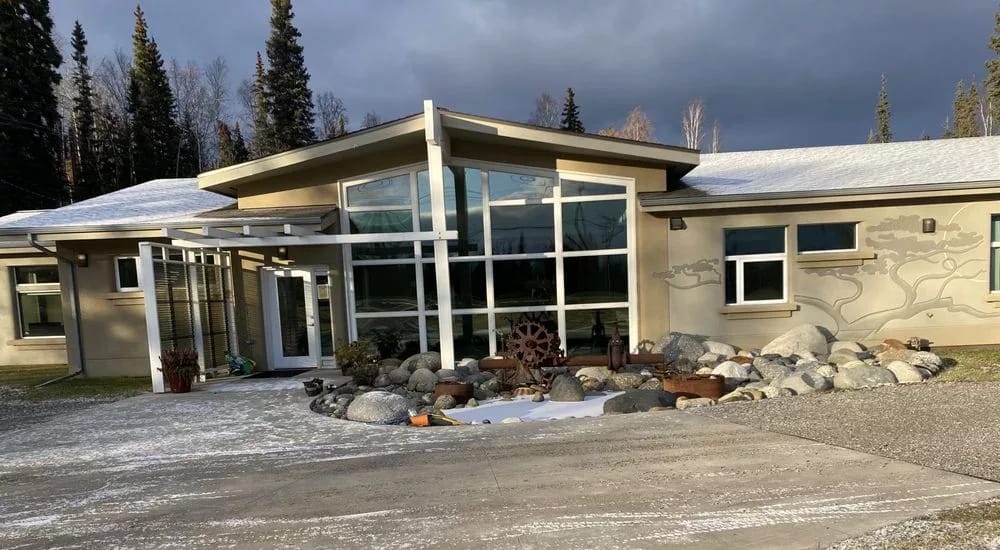 Exterior view of a senior living facility with landscaping