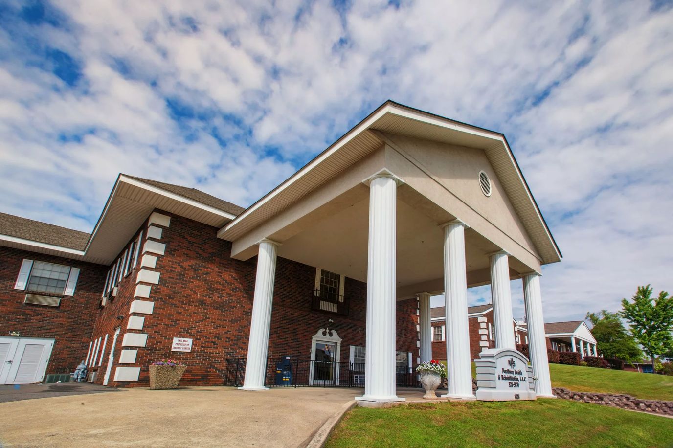 Exterior view of the facility with columns and signage