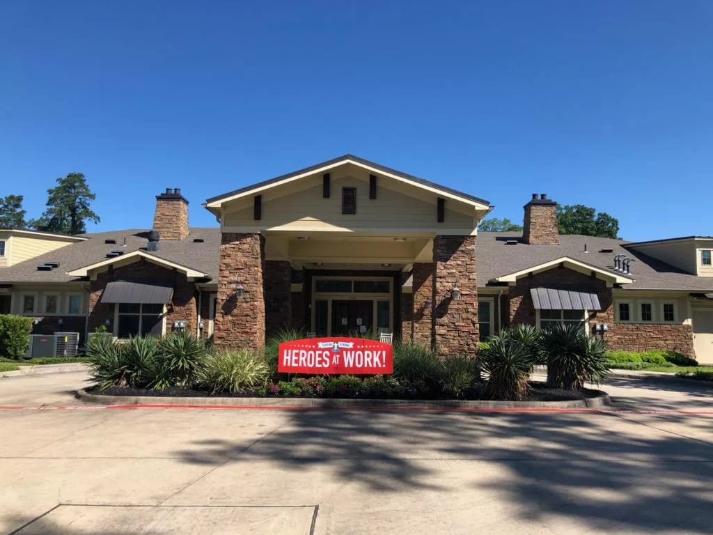 Exterior view of senior living facility with signage
