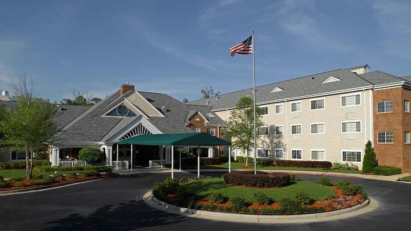Exterior view of the senior living facility with landscaping