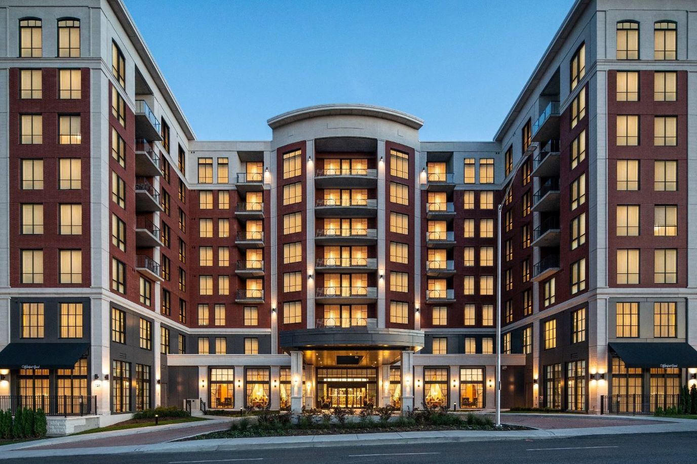 Exterior view of Waterford Grand Retirement Community building at dusk