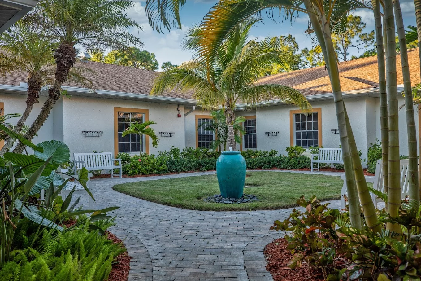 Lush courtyard with palm trees and benches