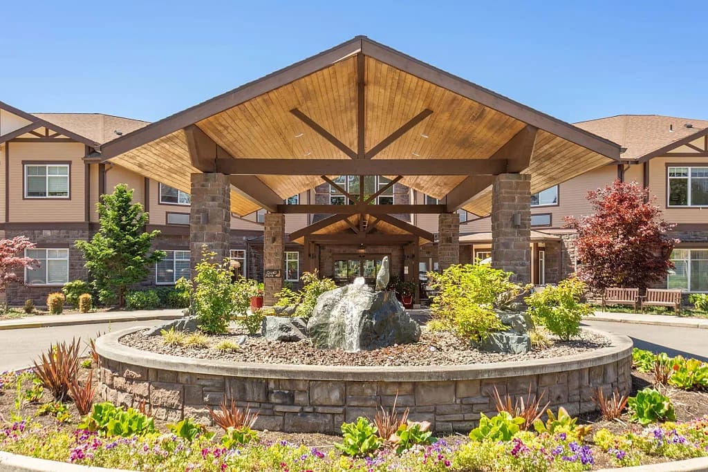 Entrance of a senior living facility with landscaped gardens