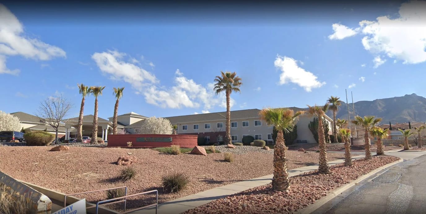 Exterior view of Royal Estates of El Paso with palm trees