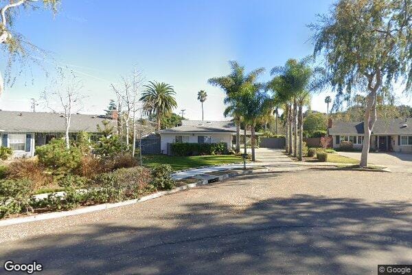 Outdoor view of a senior living facility with palm trees