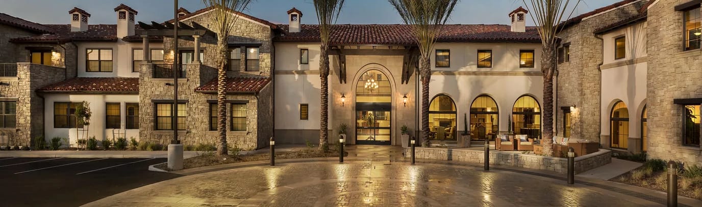 Exterior view of a senior living facility with landscaping