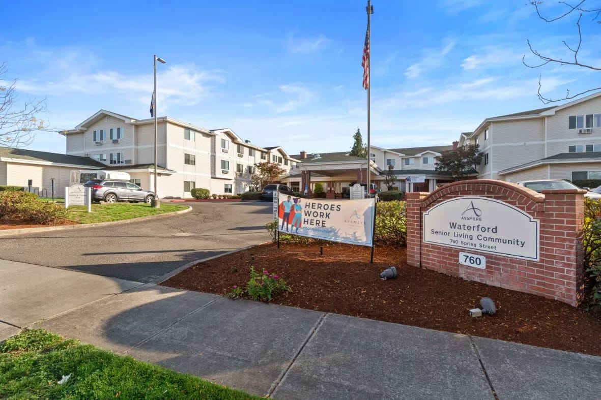 Entrance of a senior living community with a welcoming sign