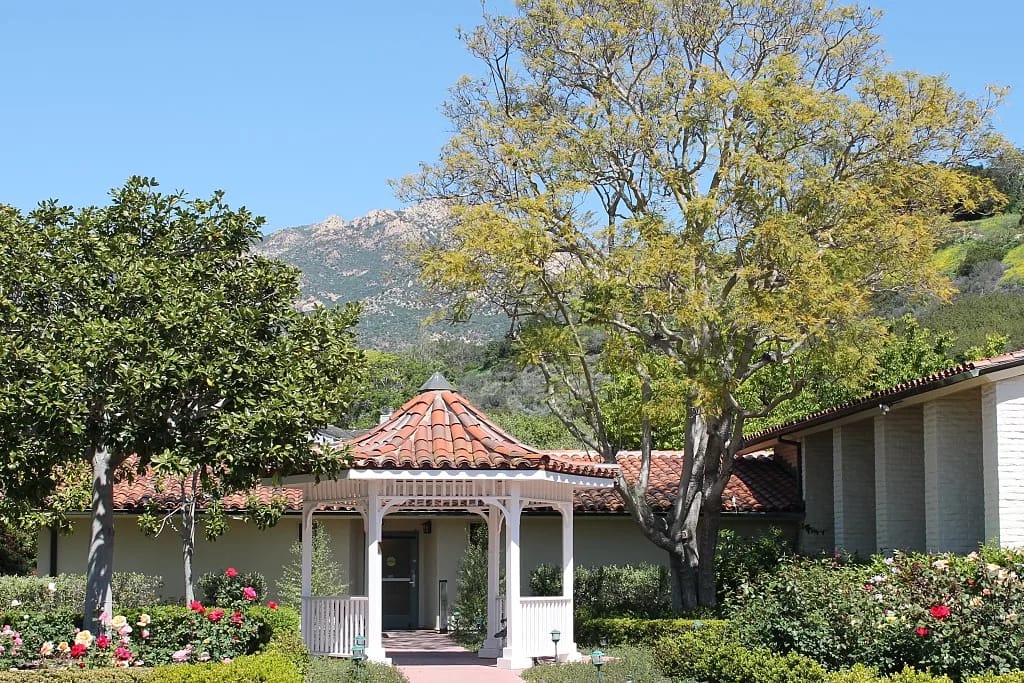 Exterior view of the facility with landscaped gardens
