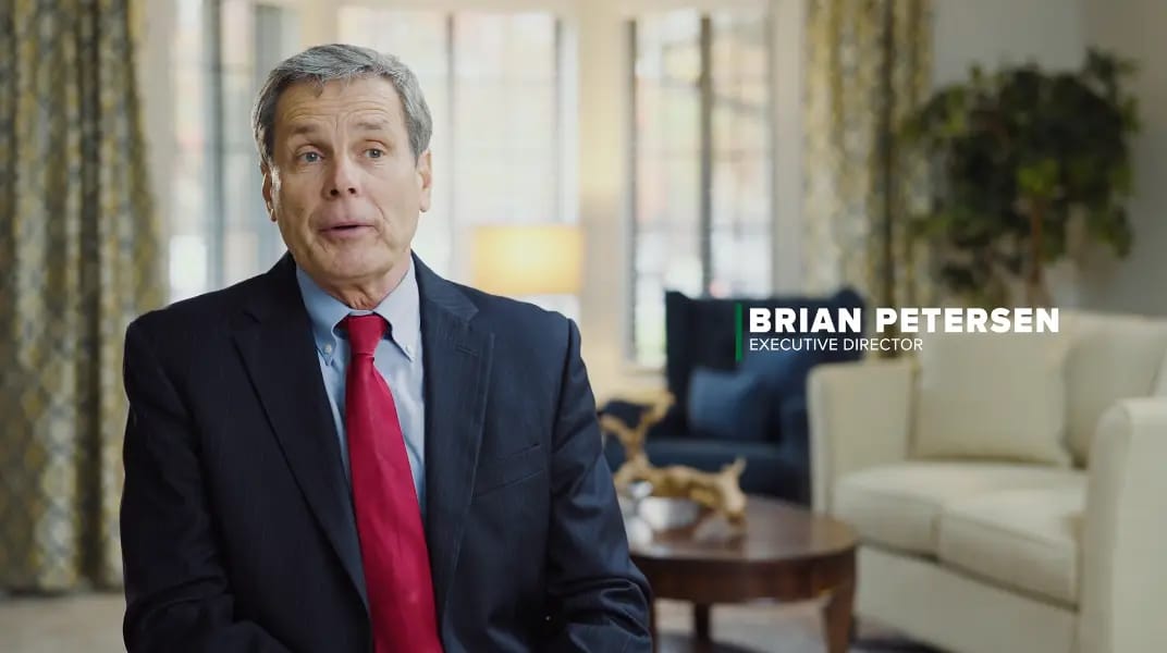 Executive Director speaking in a cozy interior setting