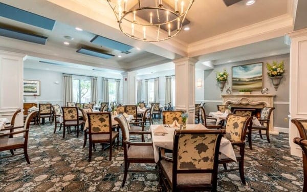 Elegant dining room with tables set for residents