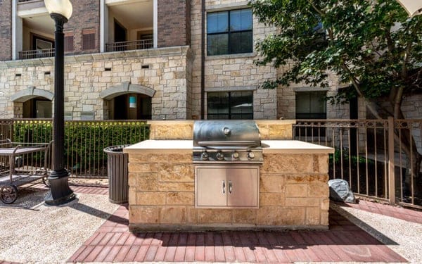 Outdoor grilling area with a stone backdrop