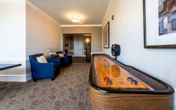 Interior view of a common area with shuffleboard table