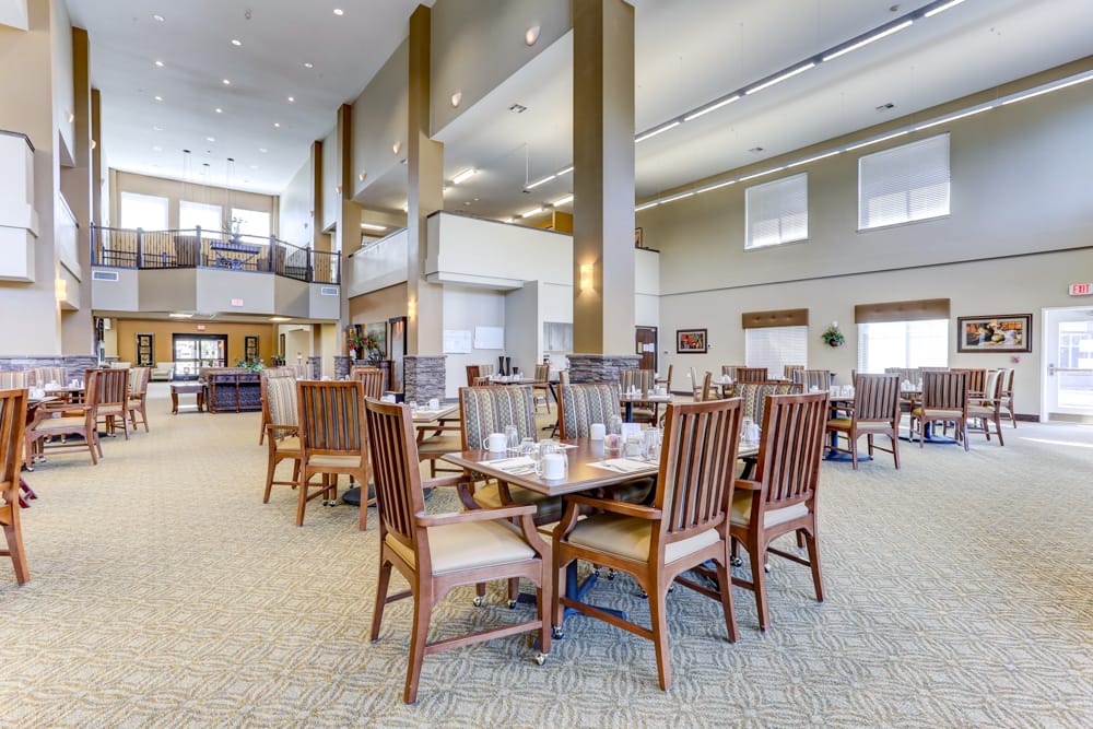 Spacious common area with dining tables and chairs.