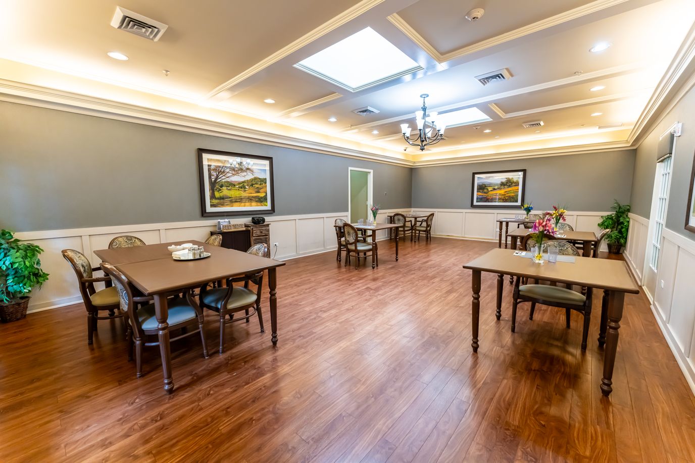 Common room with tables and floral arrangements