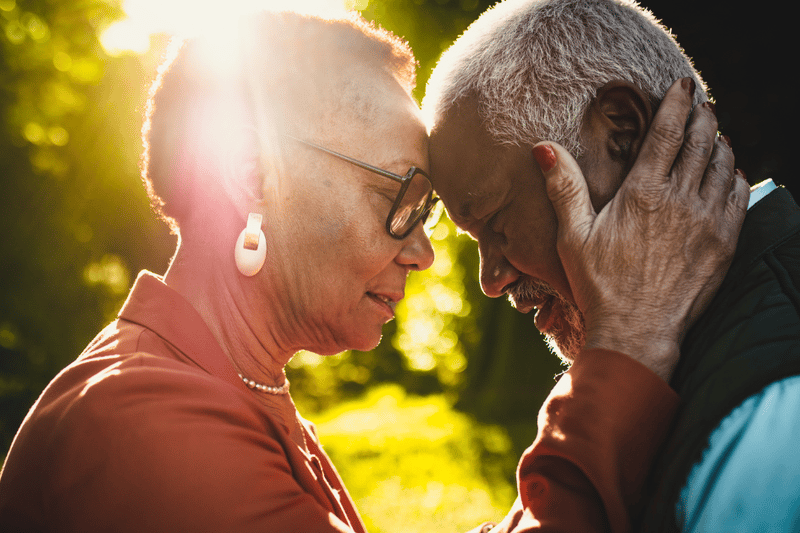Salus Home Care, home care in San Diego, CA — Elderly couple embracing in a sunlit outdoor setting