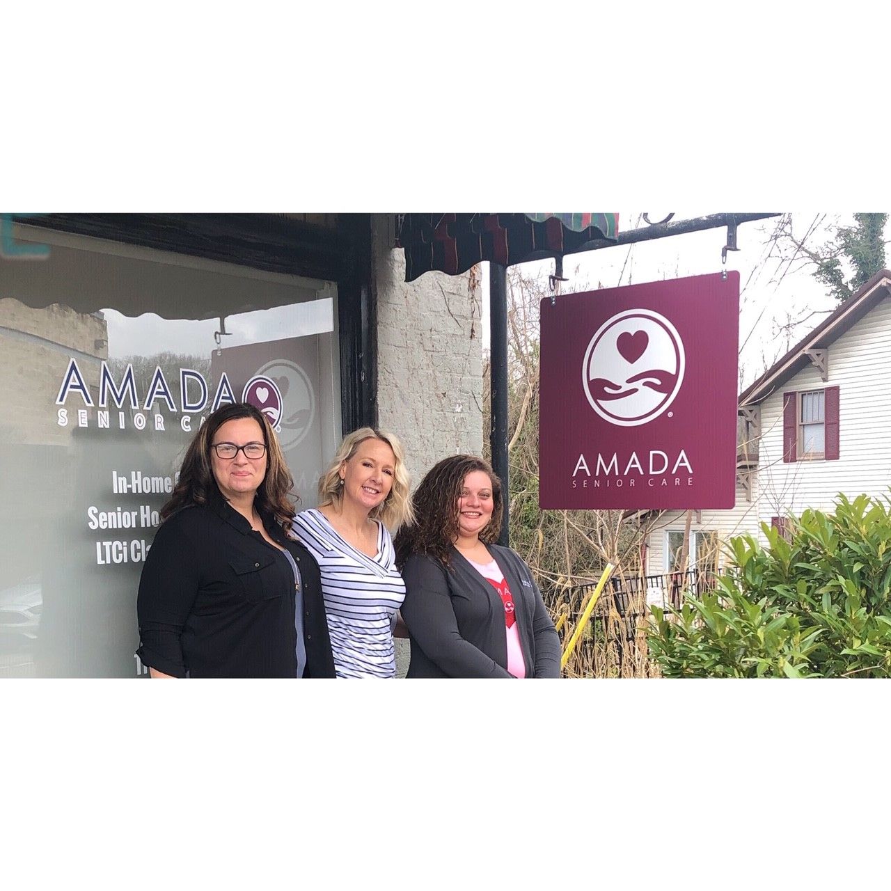 Staff members posing outside the facility entrance