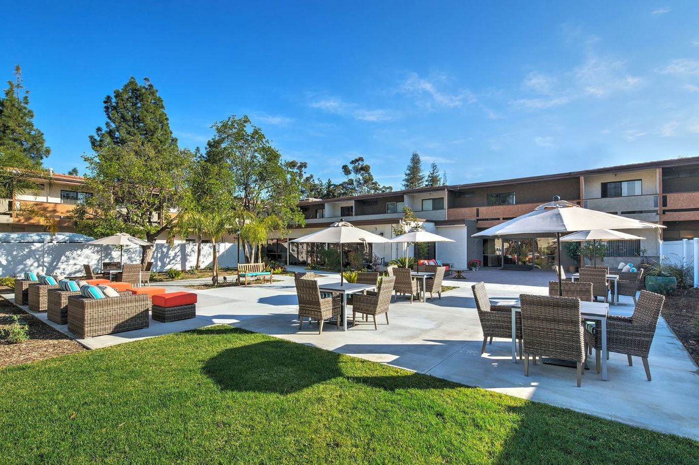 Outdoor patio with seating and shaded umbrellas