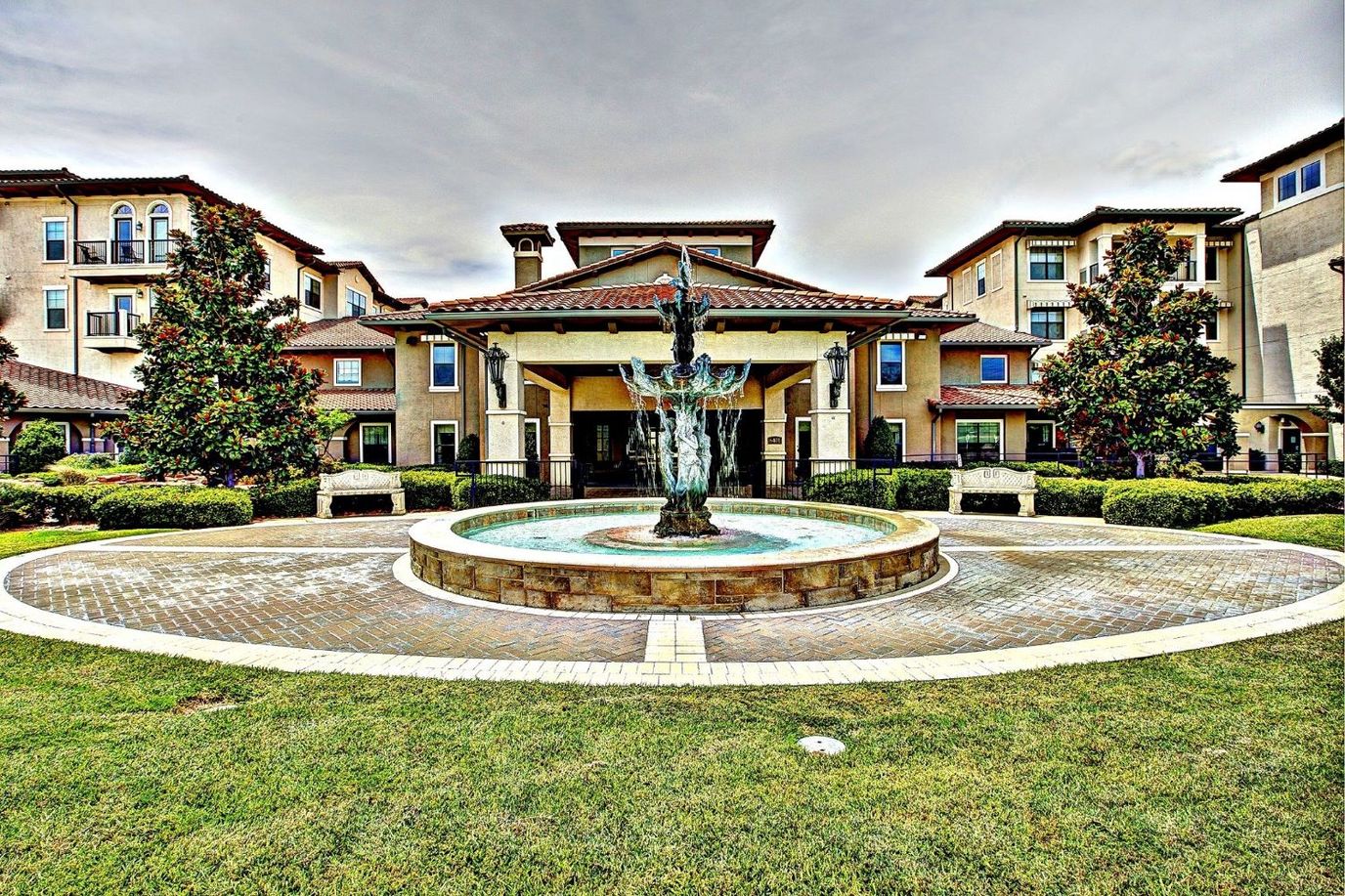 Exterior view of the facility with a fountain and garden