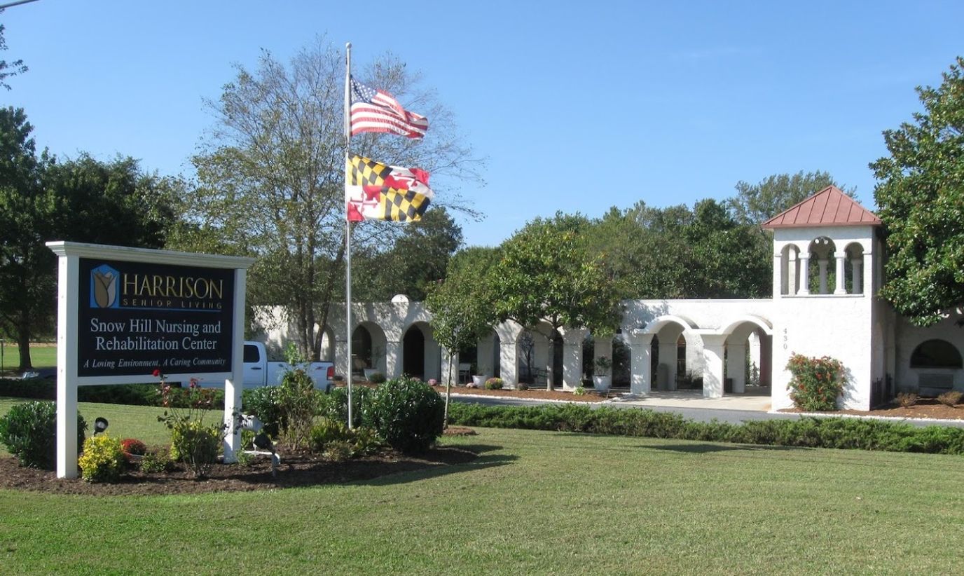 Exterior view of Harrison House of Snow Hill with signage