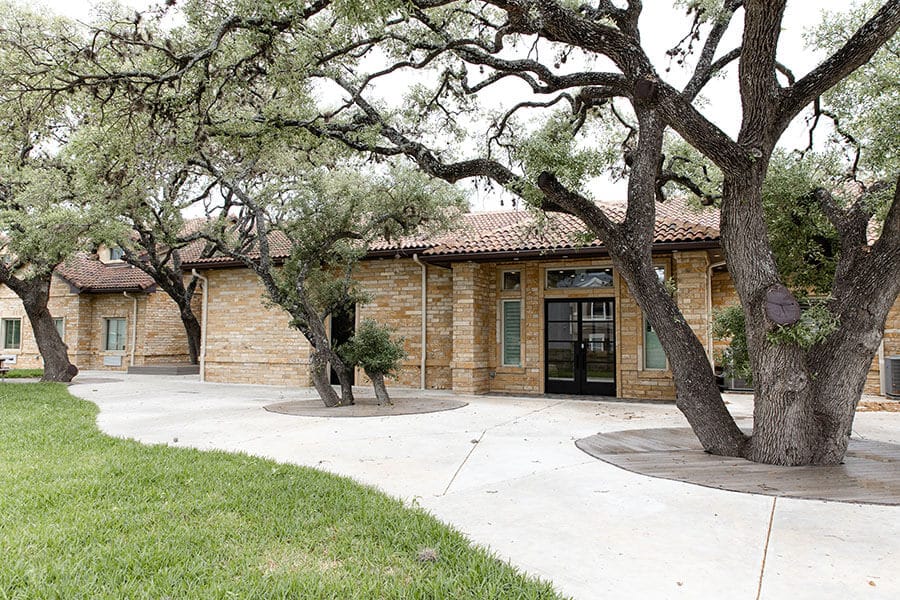 Front entrance of Heritage Creek with landscaping and trees