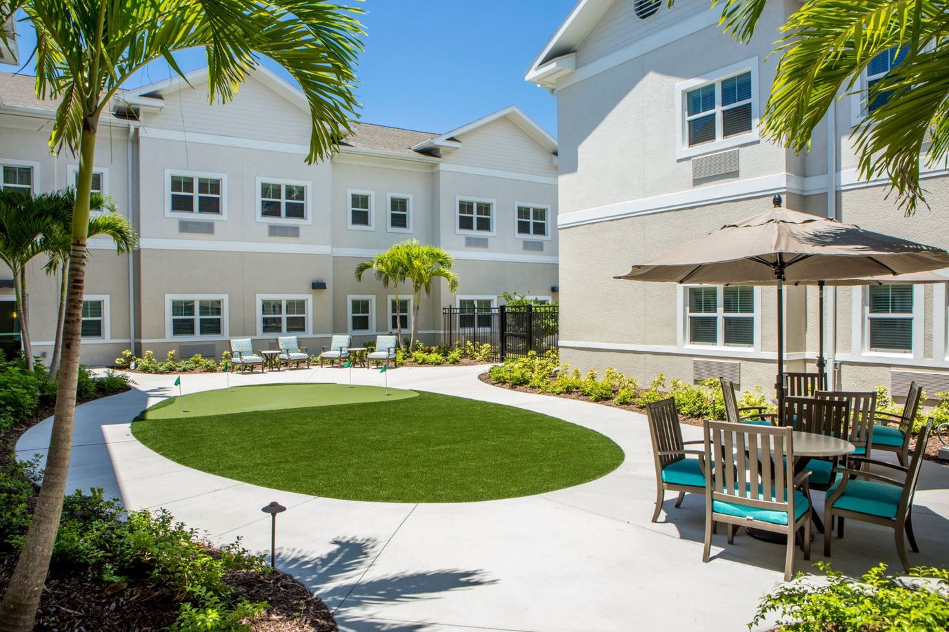 Sunny courtyard with greenery and seating