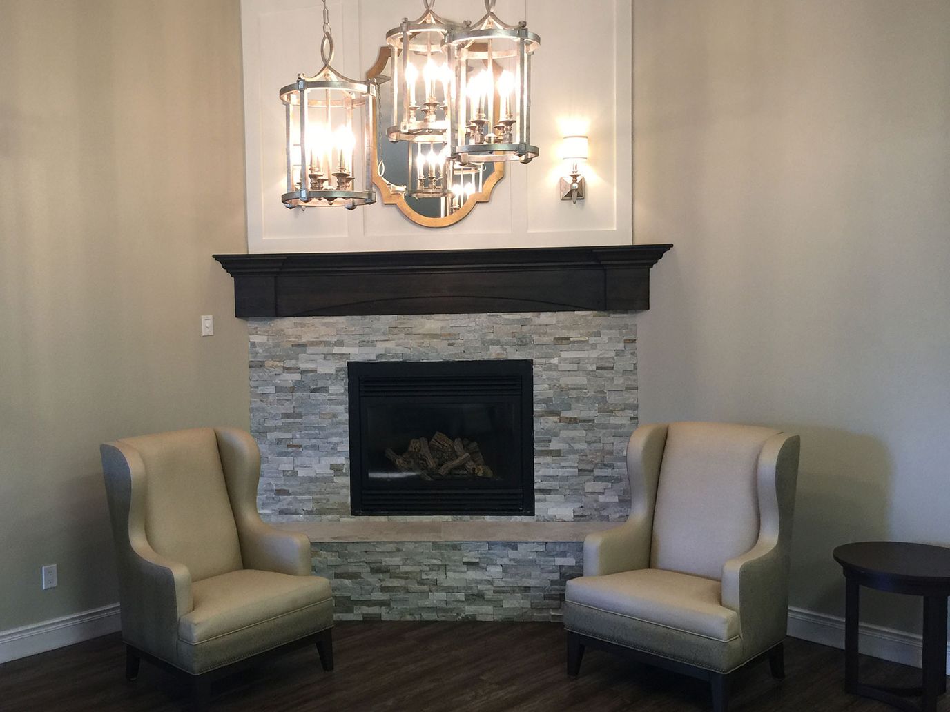 Comfortable seating area with a fireplace and chandelier