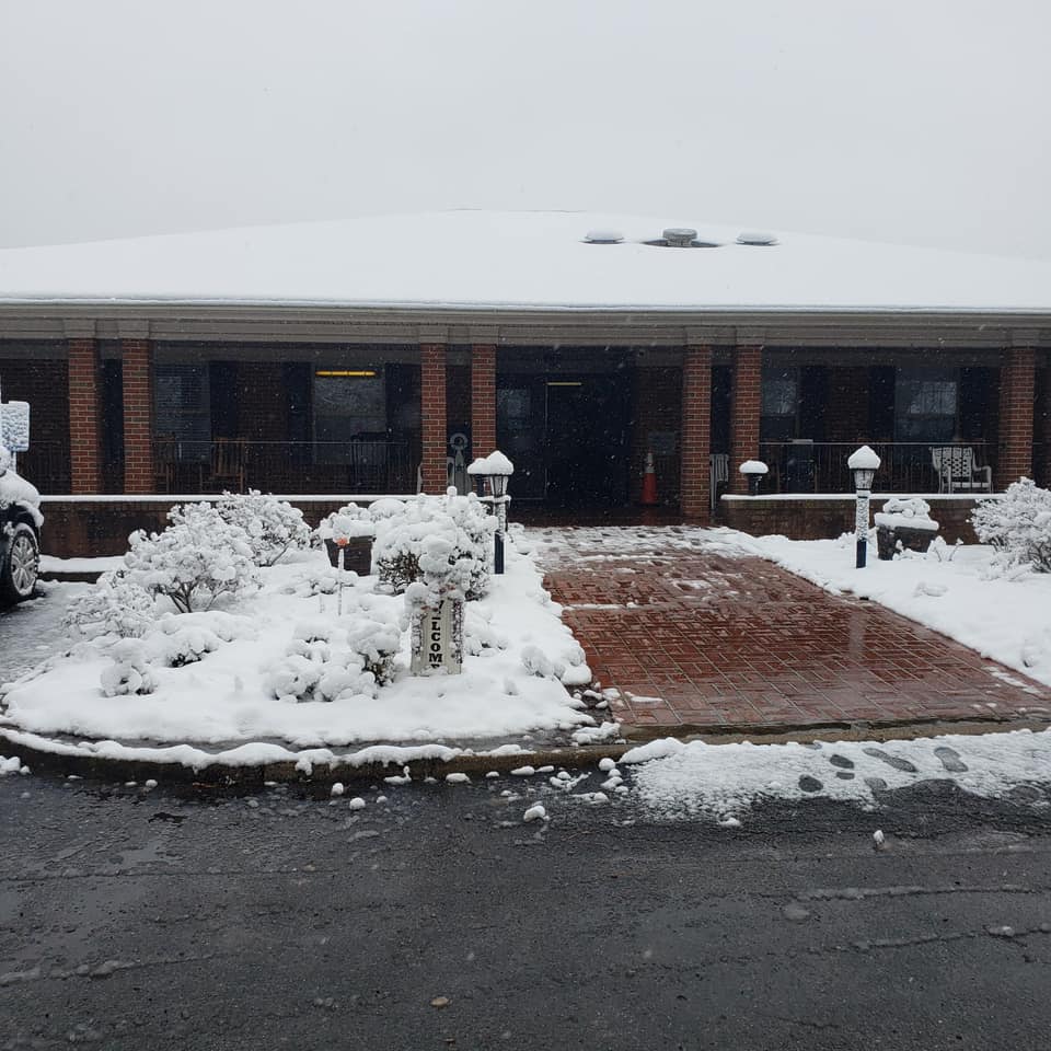 Exterior view of an assisted living facility covered in snow