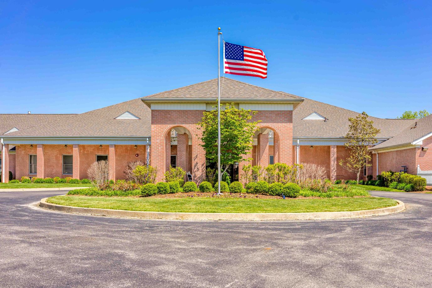 Exterior view of assisted living facility with flag