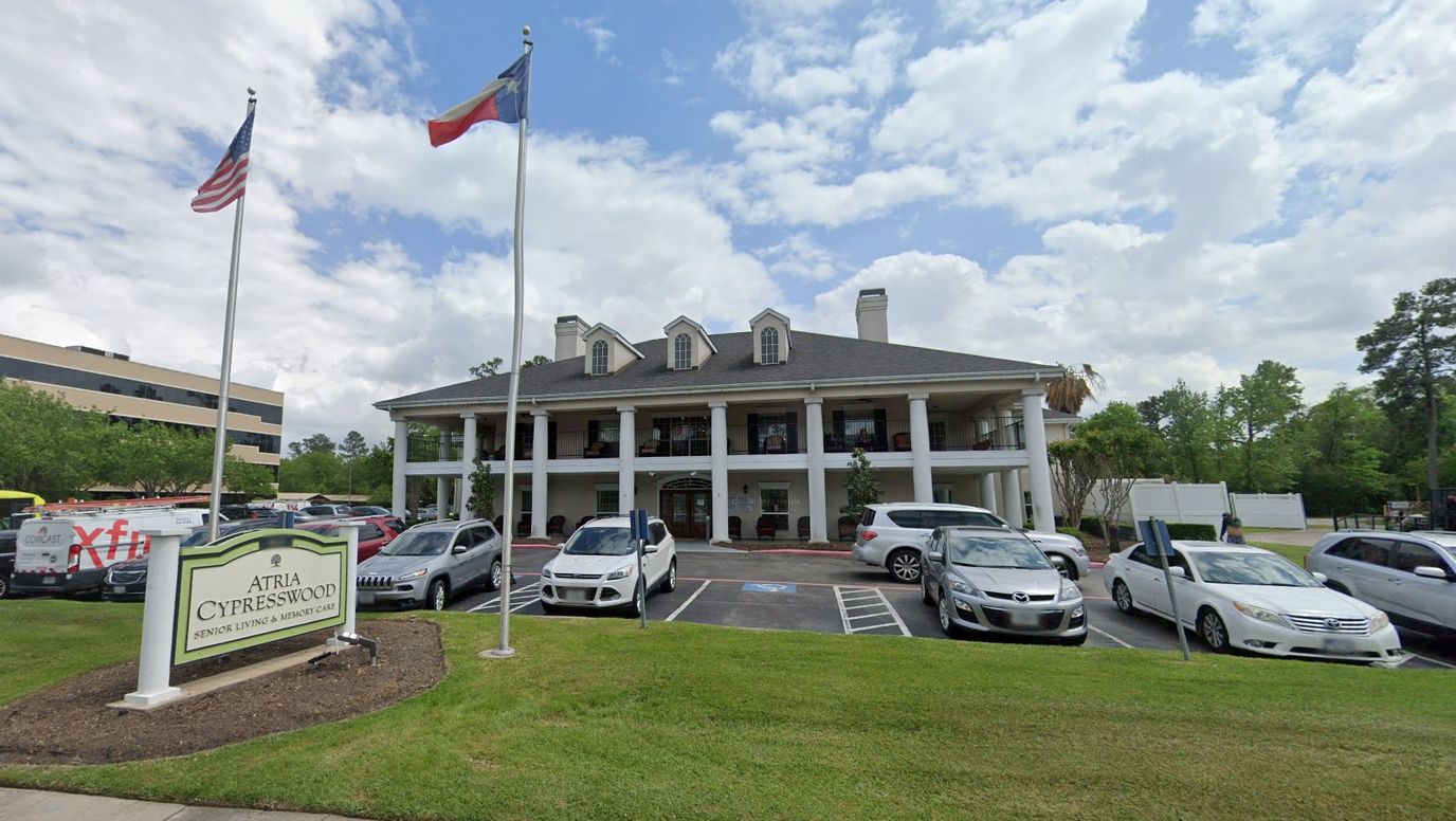 Exterior view of Novellus Cypresswood facility with flags and cars