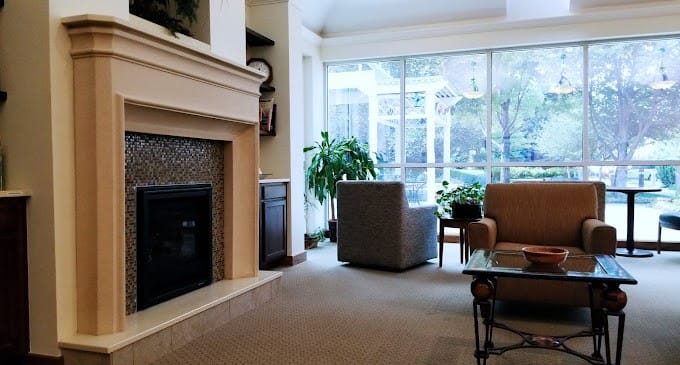 Cozy common area with fireplace and natural light