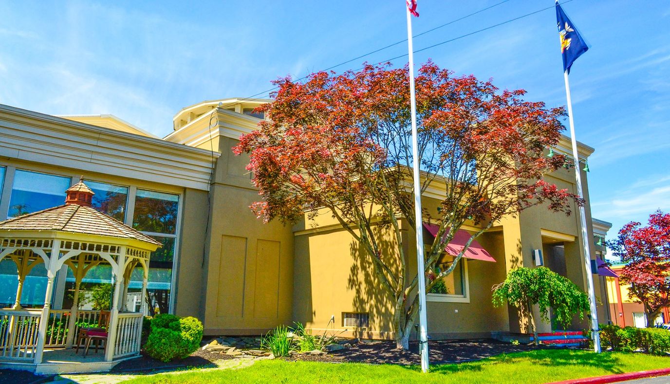 Exterior view of the facility with landscaping and gazebo