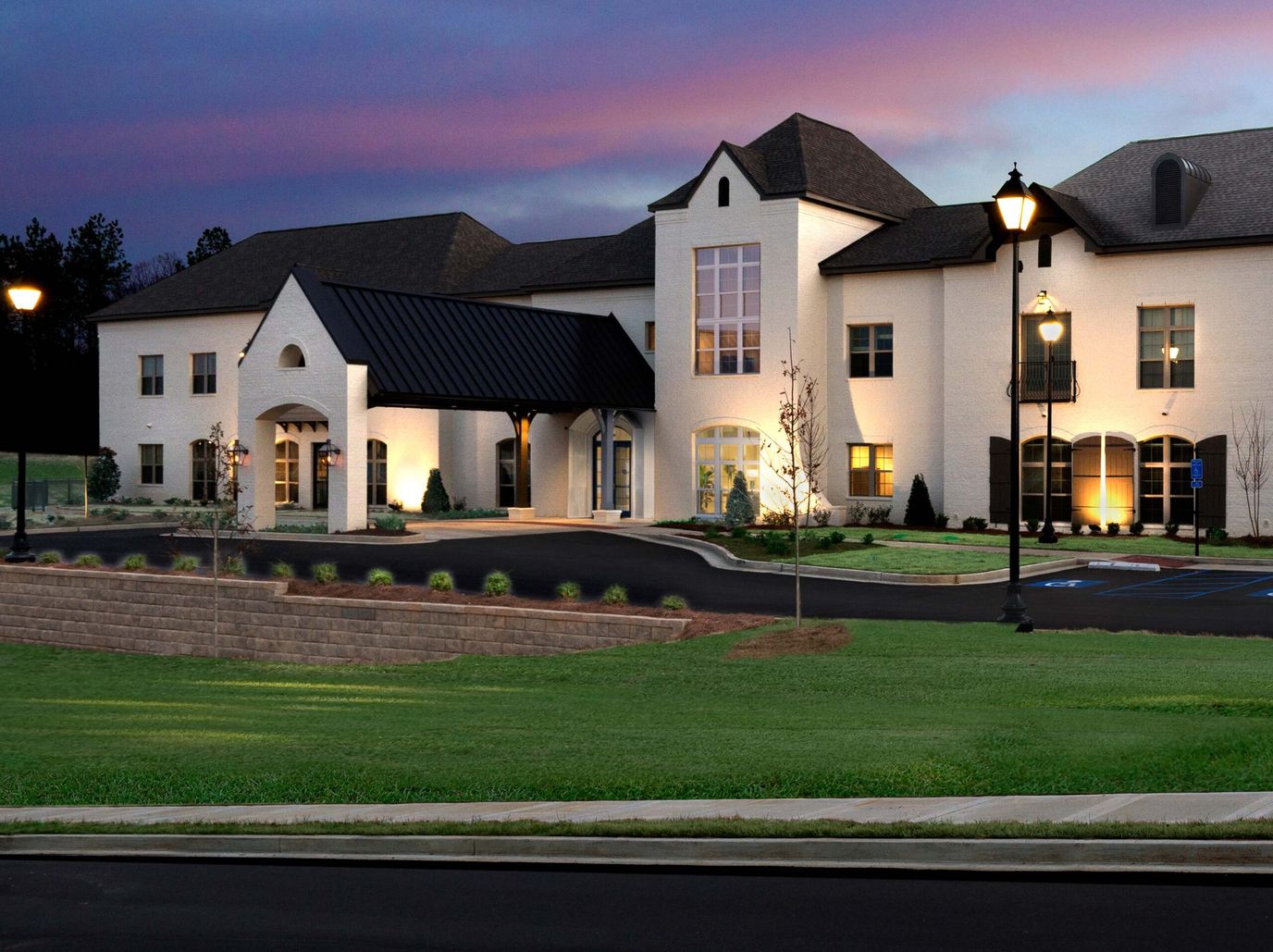 Exterior view of The Magnolia at Oxford Commons with illuminated landscaping