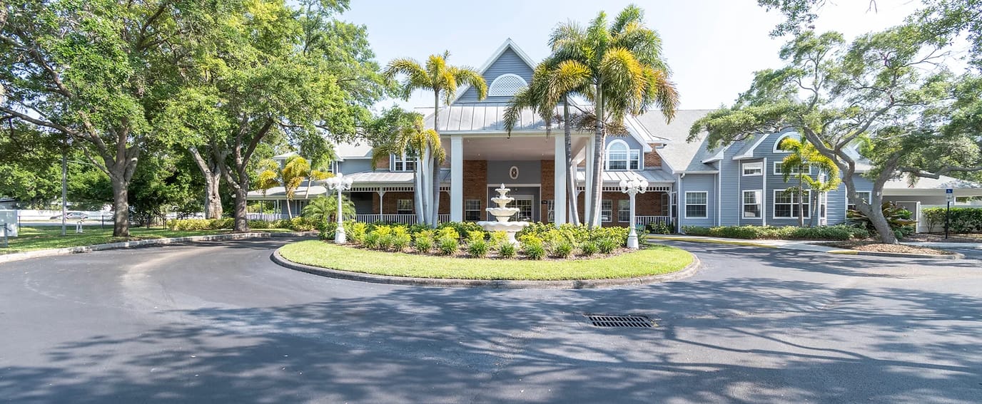 Exterior view of a senior living facility with landscaping