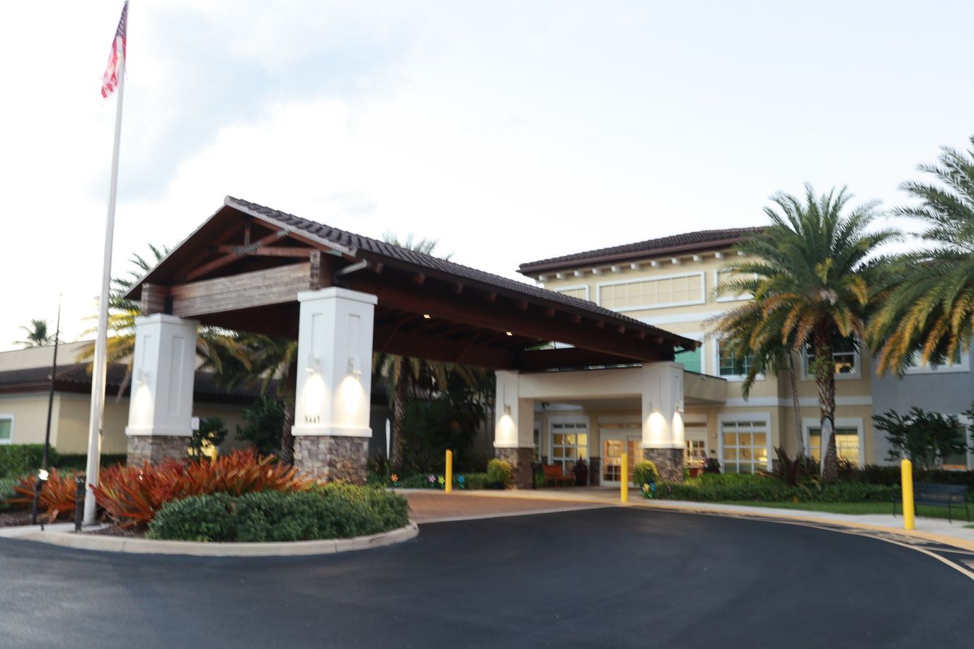 Entrance of the assisted living facility with palm trees