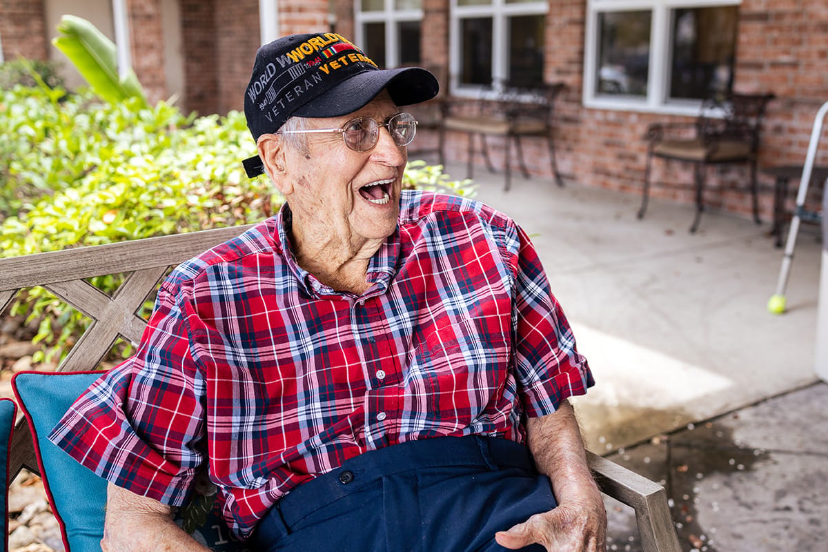 Senior resident smiling outdoors in casual attire