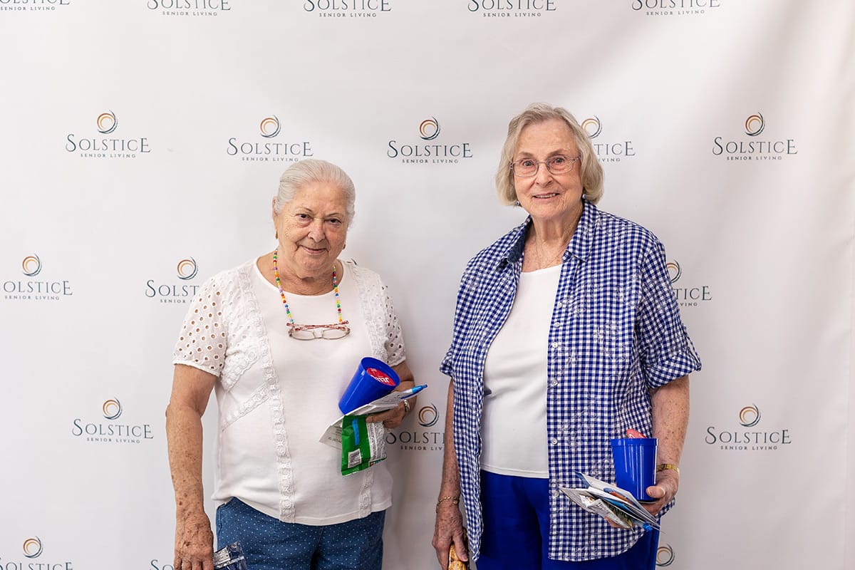 Two residents smiling together at an event